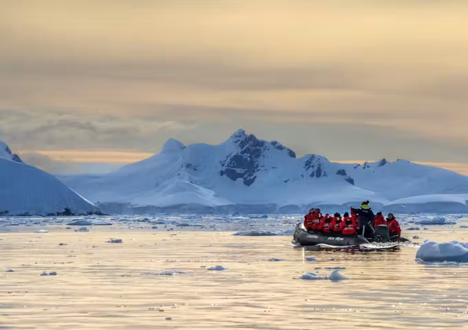Zodiac cruising during a late season sunrise in Wilhemina Bay