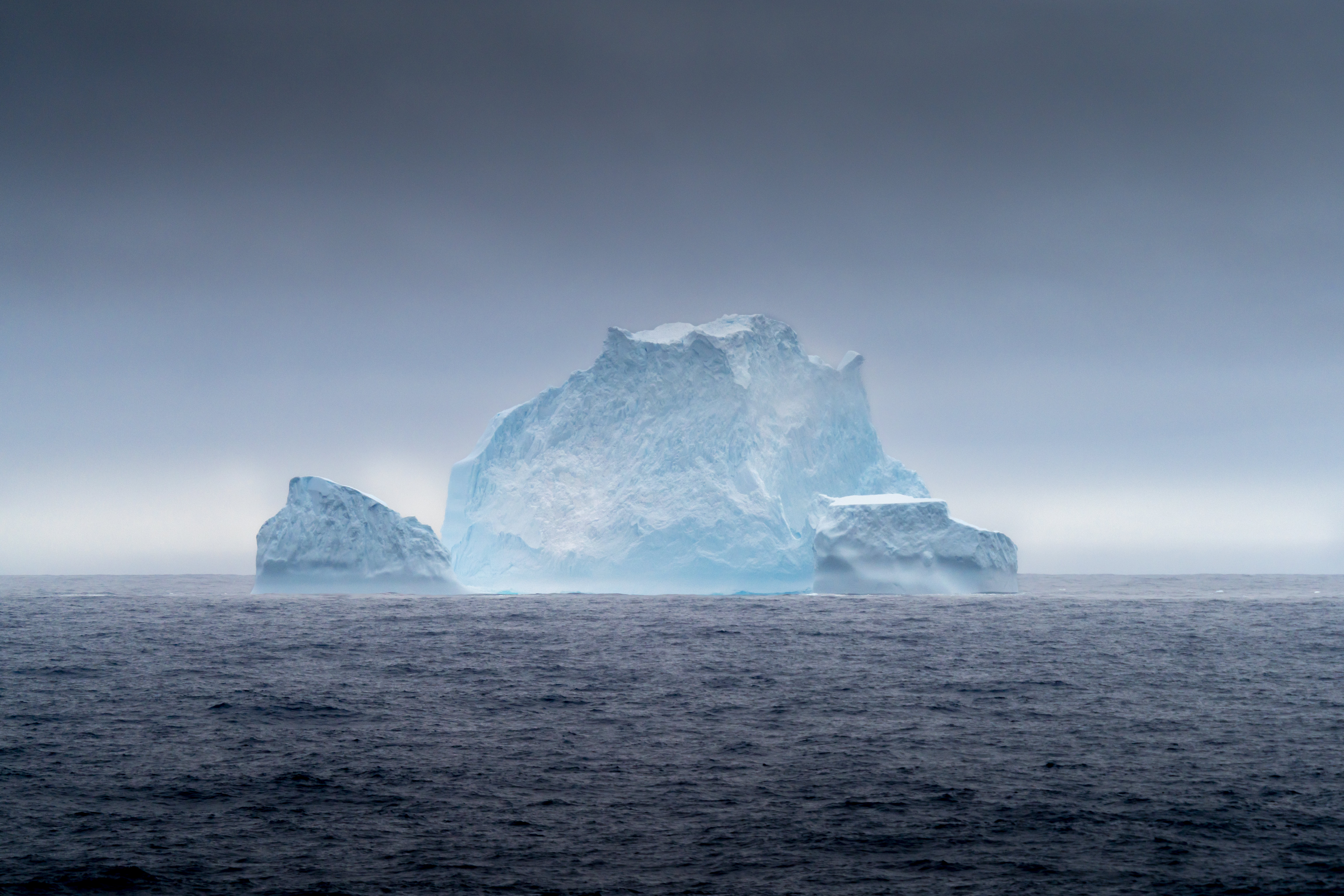 Iceberg in Antarctica with moody clouds