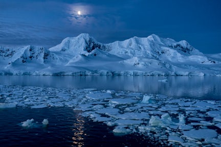 Antarctic coastline in moonlight