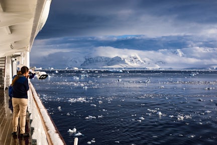 Looking out from a ship's deck across to the snowy landscape of the South Shetlands, Antarctica