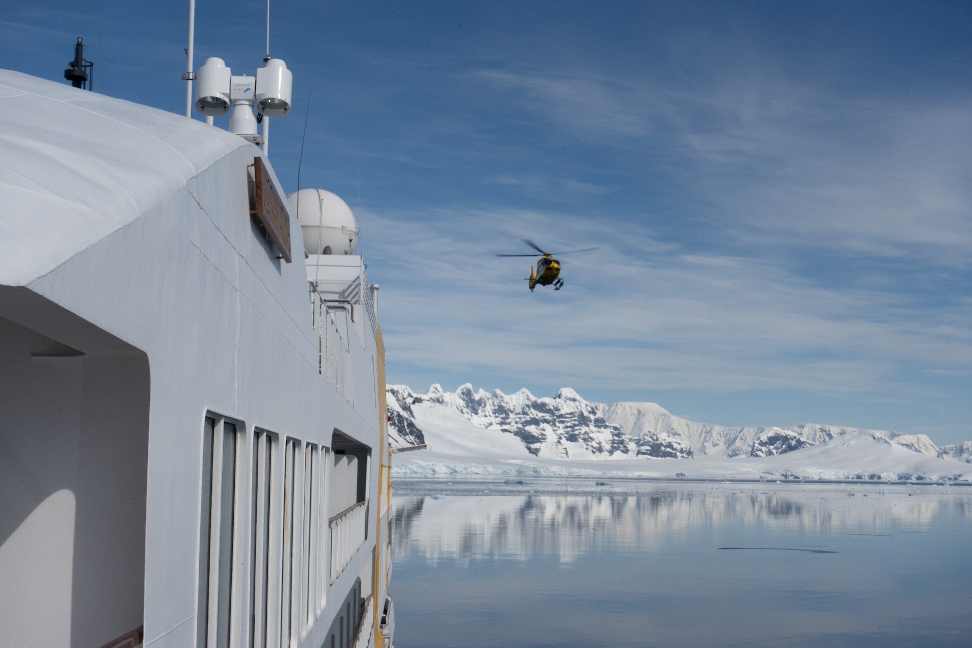 A helicopter returns to a ship in Antarctica