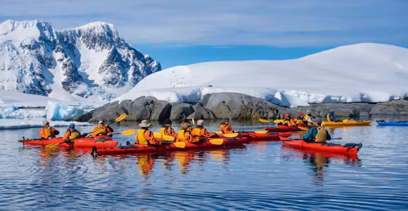 Kayakers gather in a group Pleneau Island, Antarctica