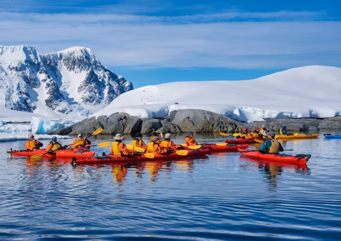 Kayakers gather in a group Pleneau Island, Antarctica