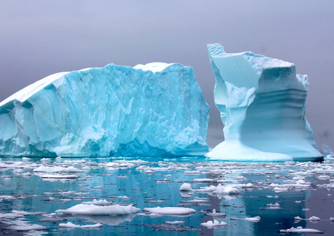 An iceberg in Antarctica surrounded by ice-choked waters