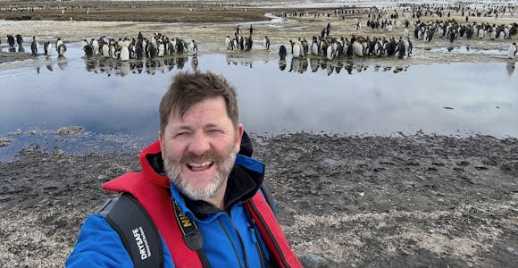 Otto from Swoop takes a selfie in front of the king penguins of Salisbury Plain