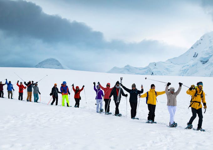 A line of snowshoers walk across Antarctica