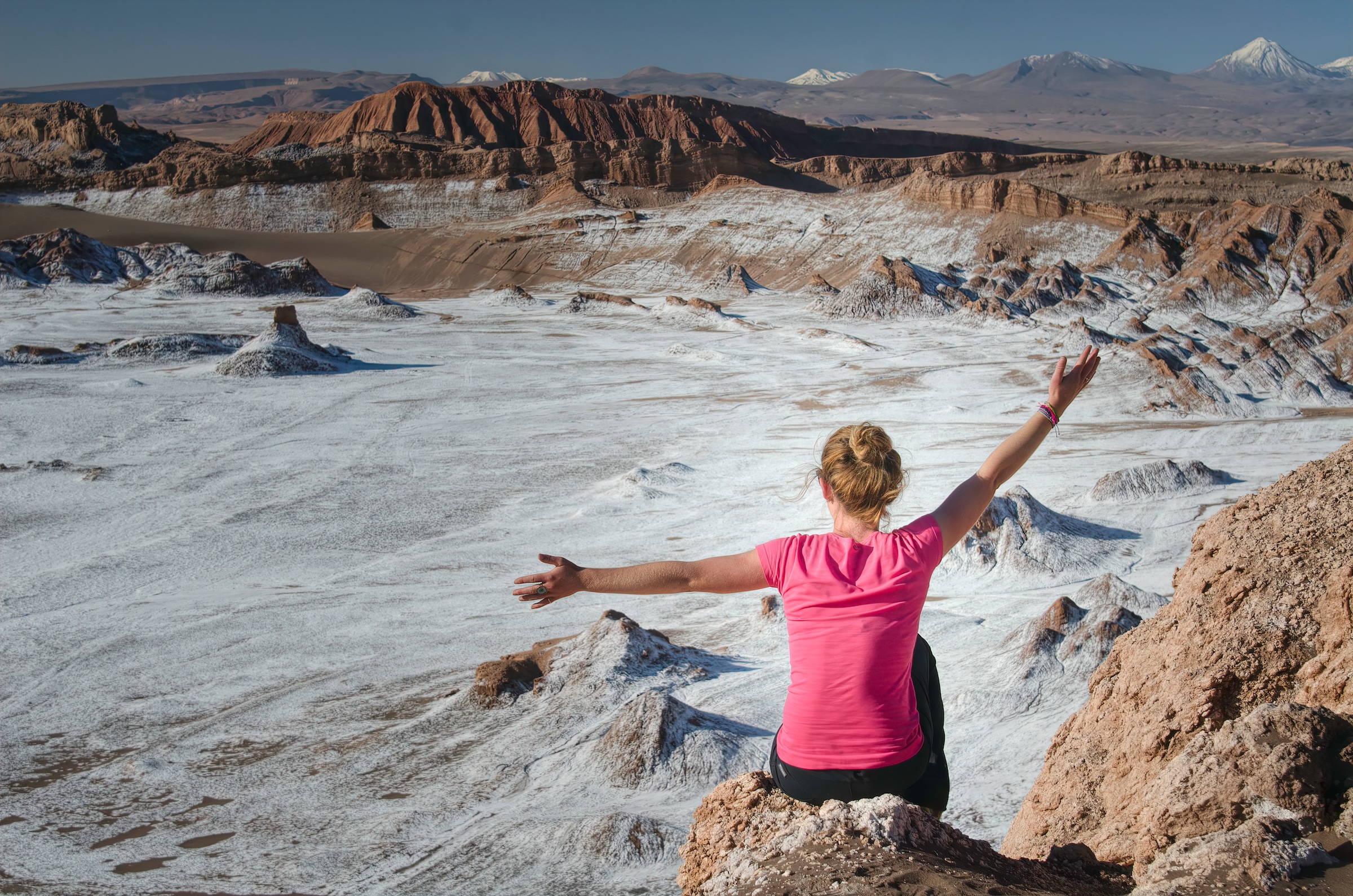 A woman enjoys a tour of Moon Valley in the Atacama Desert
