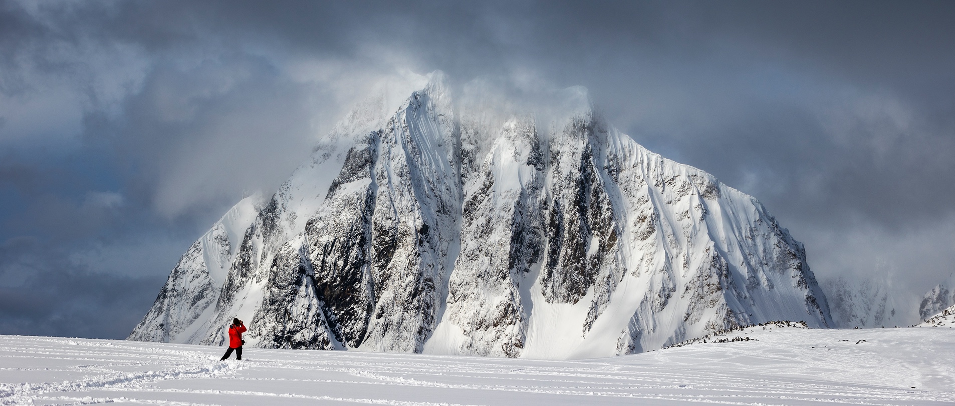 A photographer is seen taking a photograph of a mountain on Booth Island, Antarctica
