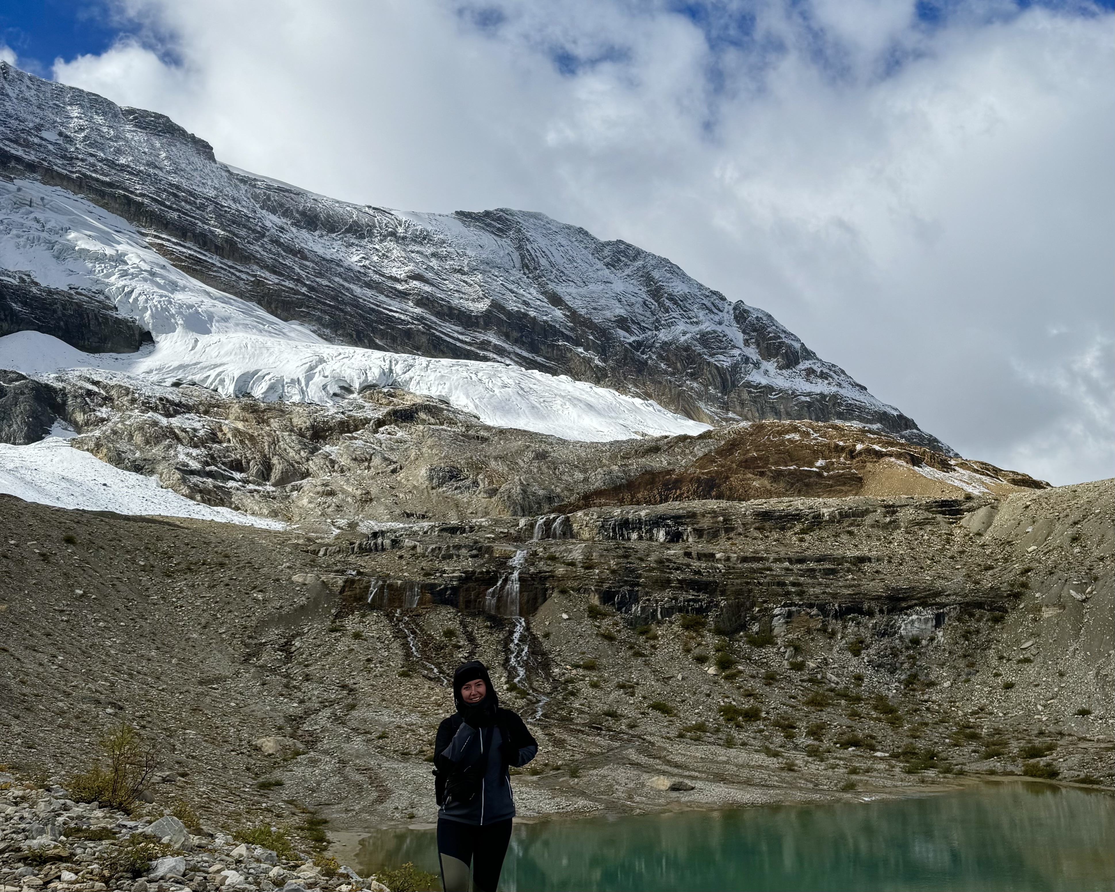 Jade standing in front of a glacier and lake at Yoho National Park