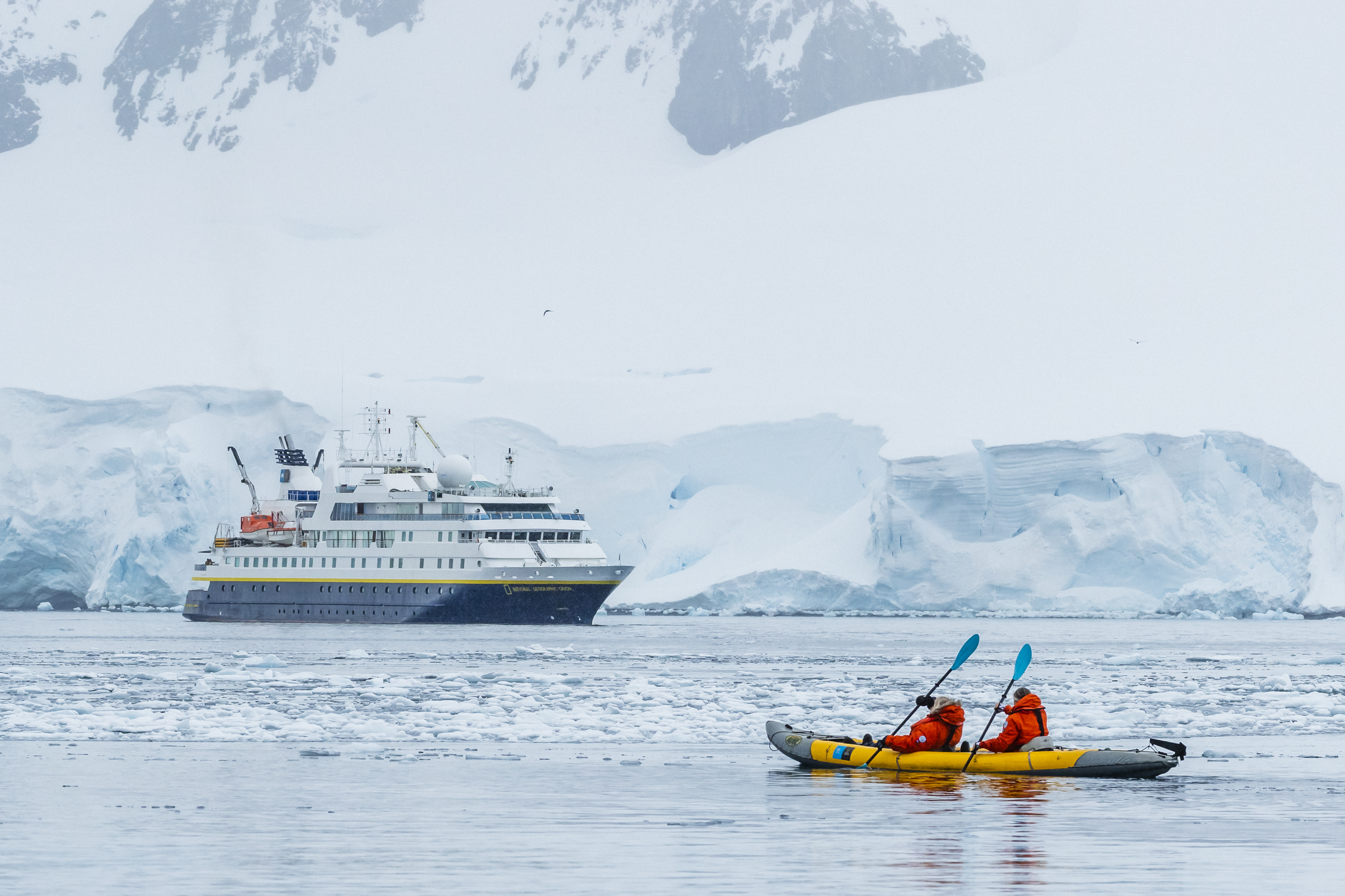 Kayaking with NG Orion in distance