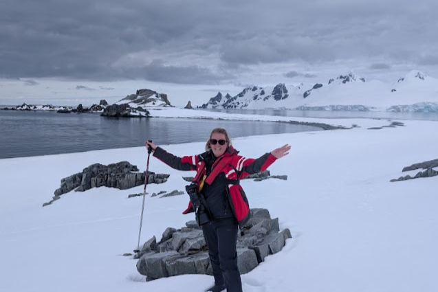 Claire standing in front of stunning Antarctic scenery